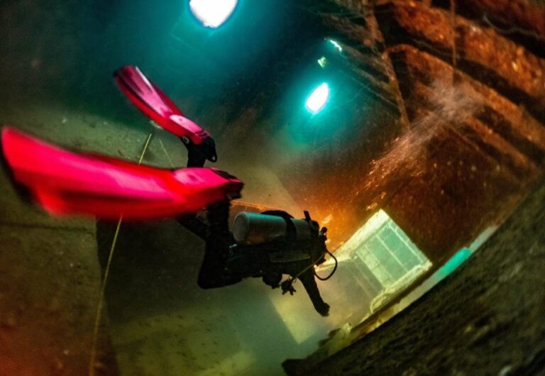 Advanced wreck scuba diver exploring the inside of a shipwreck.
