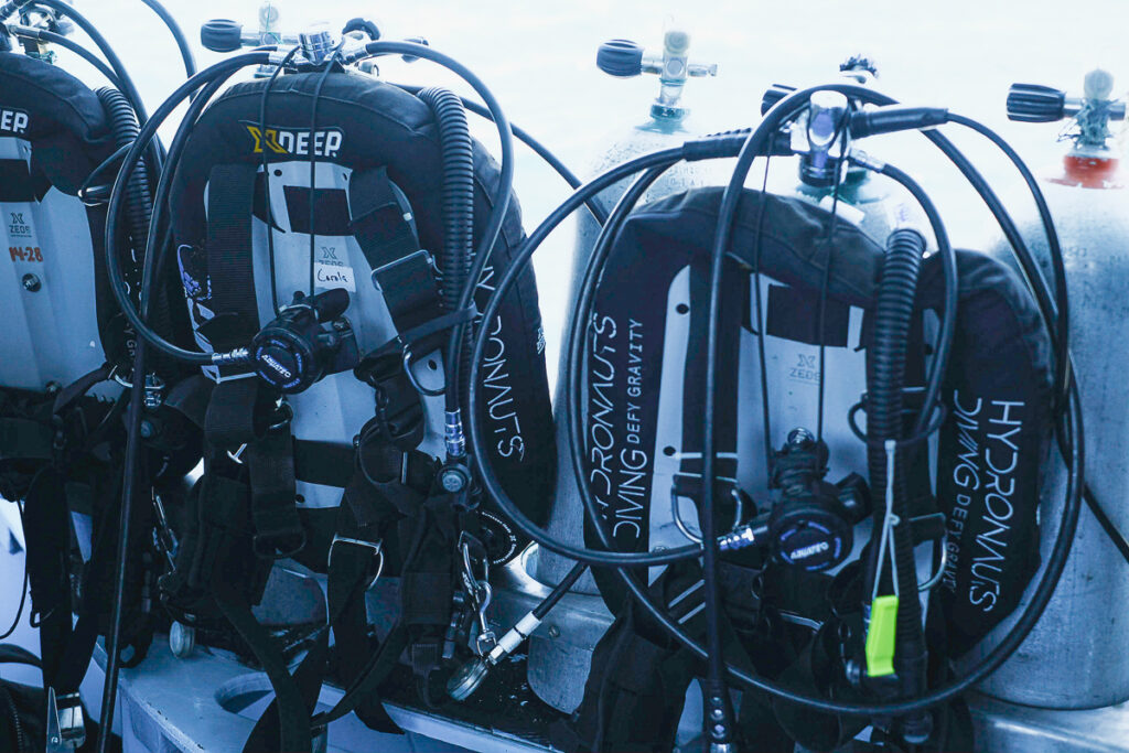 Two sets of scuba equipment ready to dive.